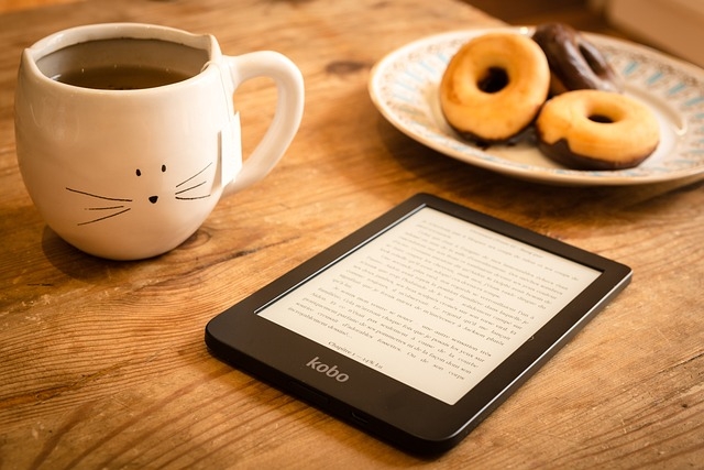 ereader, three cookies, and a cup of tea